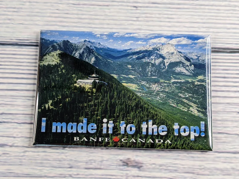 A Banff Canada magnet with an image of mountain scenery and the words, "I made it to the top!"