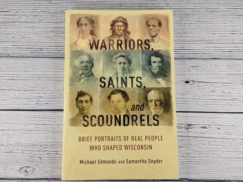 A paperback book with a tan cover that has images of historical people of Wisconsin, titled Warriors, Saints, and Scoundrels.