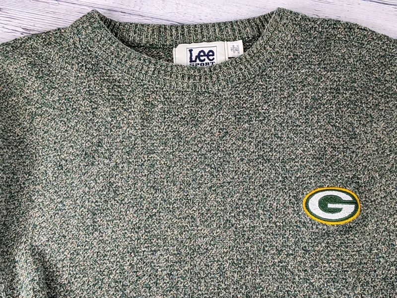 A vintage men's size xl vintage sweater, green and tan with an embroidered Green Bay Packers logo.