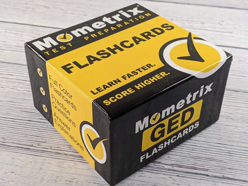 A yellow and black box of GED test preparation flashcards.