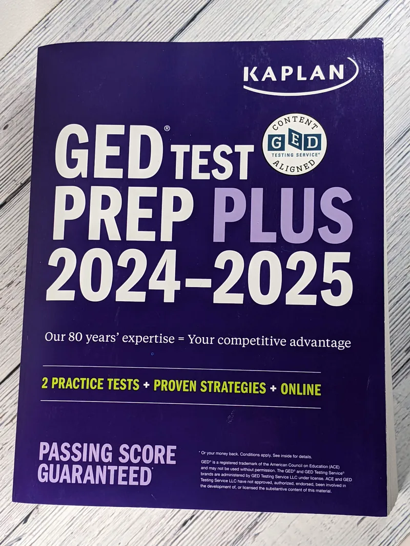 A big blue paperback book of GED test prep information.