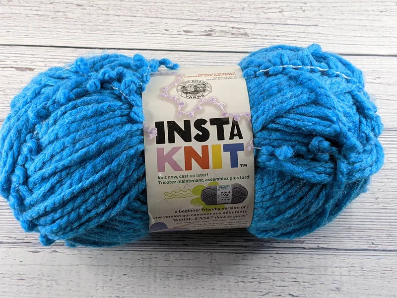Aqua blue skein of acrylic and wool insta-knit yarn.