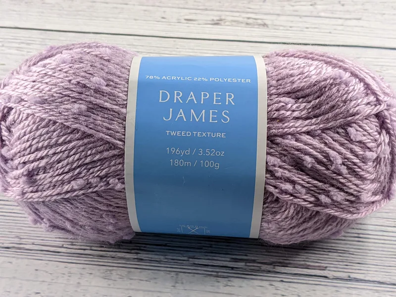 A skein of light purple textured yarn.