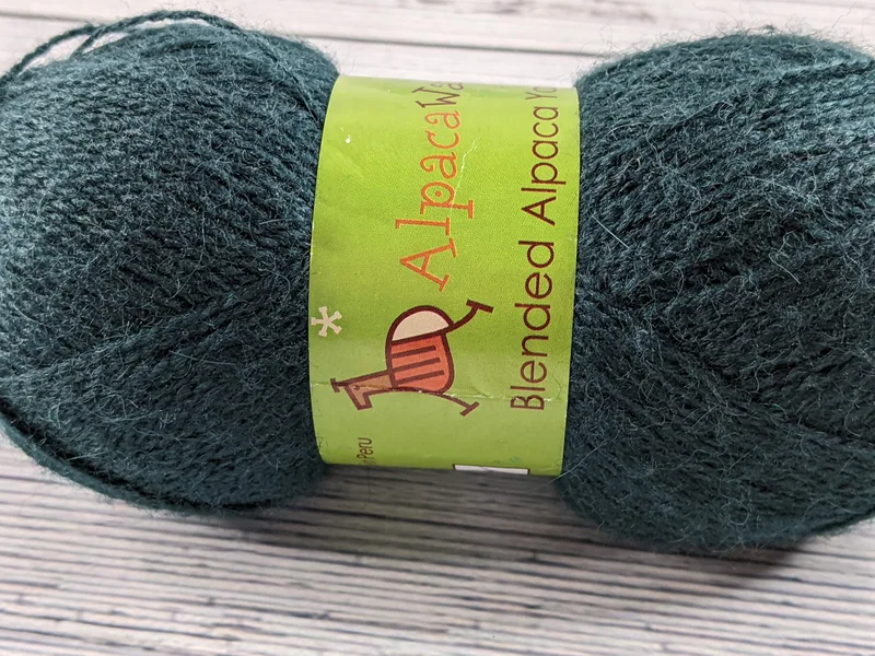 A skein of yarn that is dark teal.