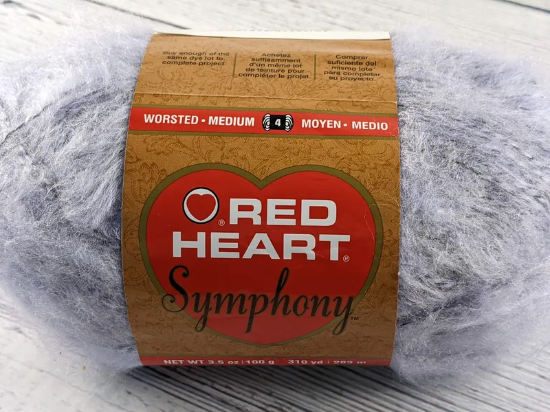 A skein of light lavender yarn by Red Heart Symphony.