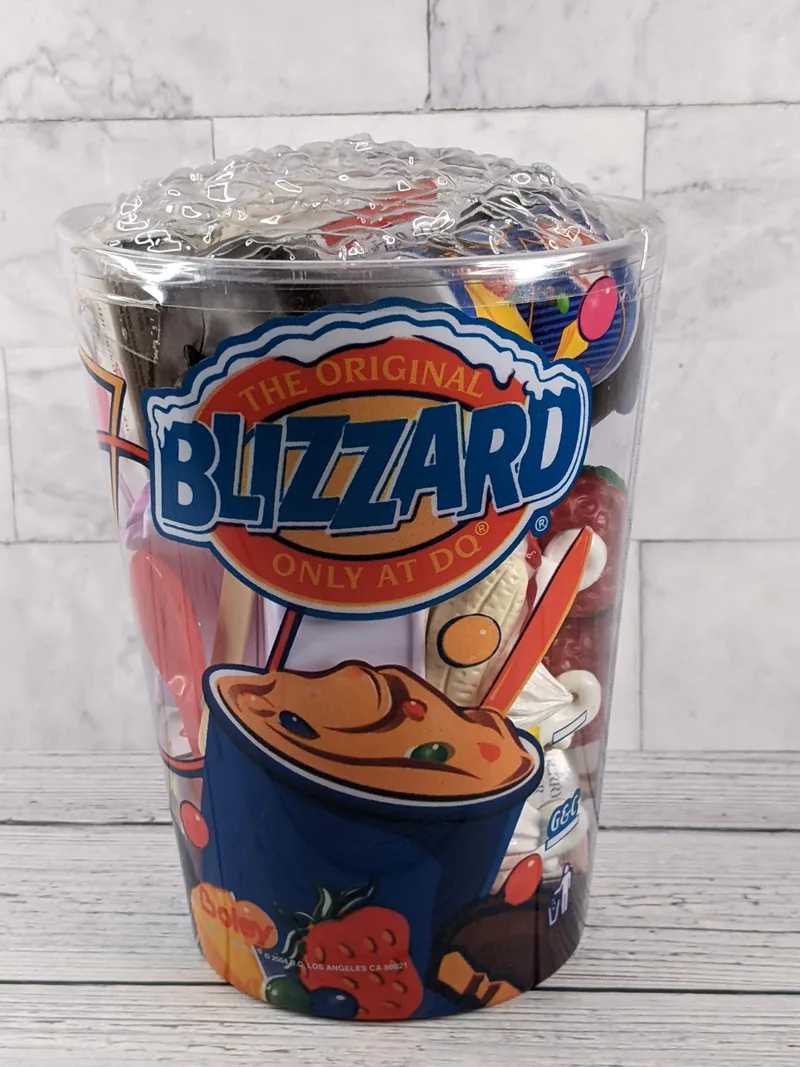 A plastic toy playset of Dairy Queen food in a DQ Blizzard shaped container.