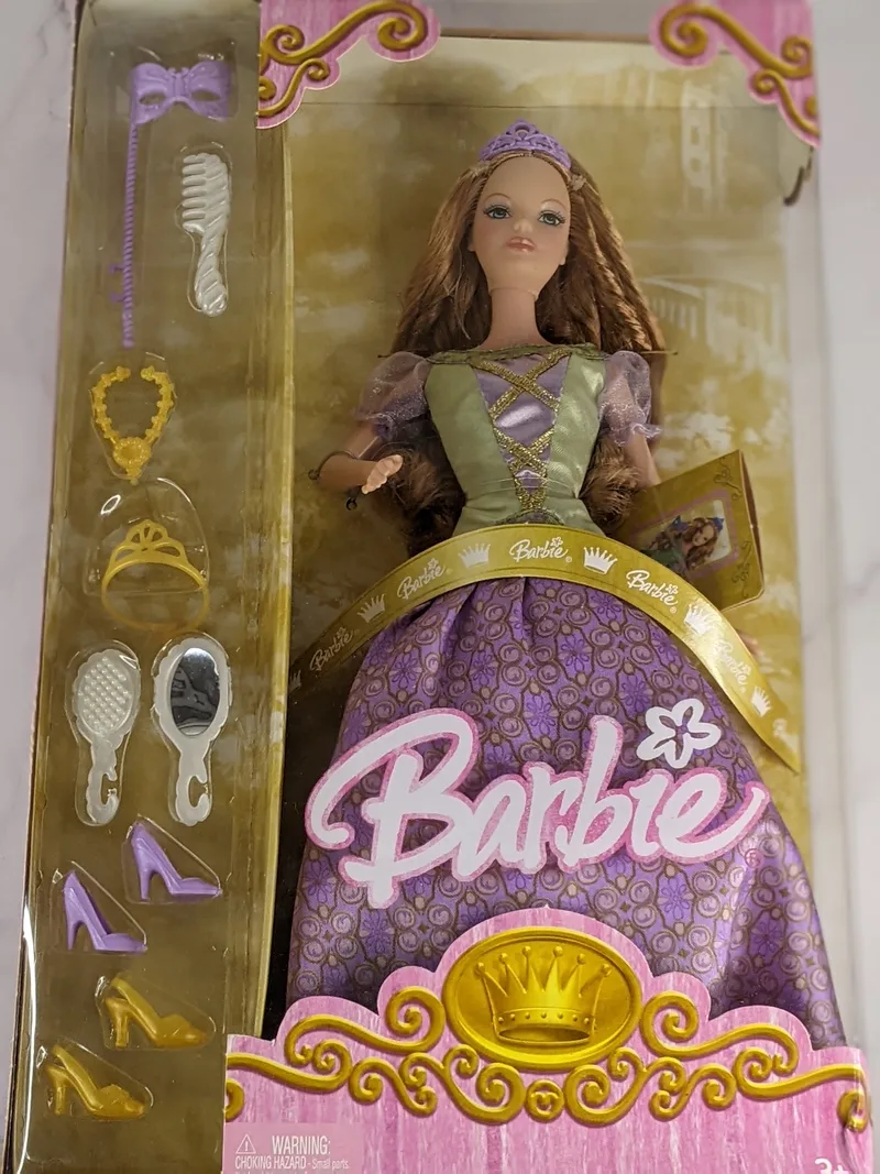 A Barbie Masquerade Princess Carnivale Ball Doll with a green and purple dress and accessories in a product box.