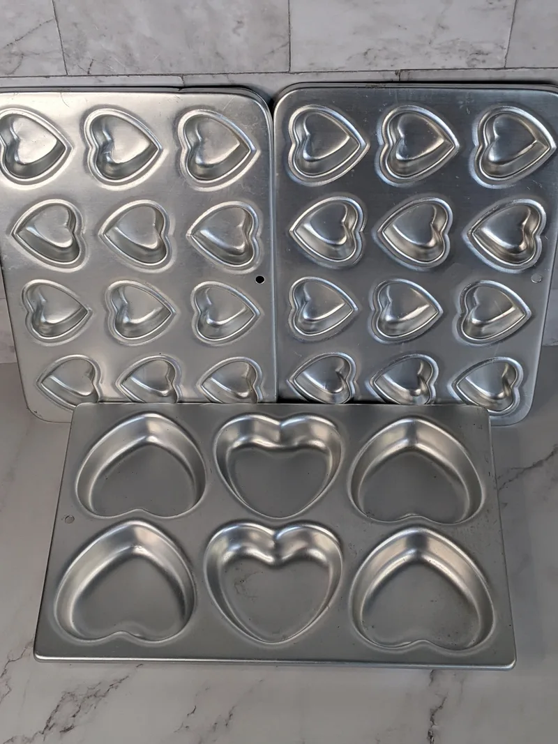 Vintage Wilton baking pans for brownies, cakes or cookies, with a heart-shaped design, three pans with two sizes of hearts.