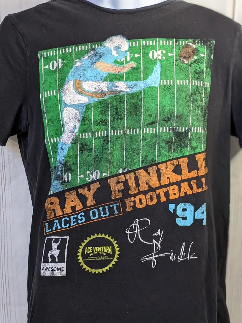 A black t-shirt, men's size medium, "Ray Finkle Laces Out" retro graphic t-shirt from Ace Ventura Pet Detective.