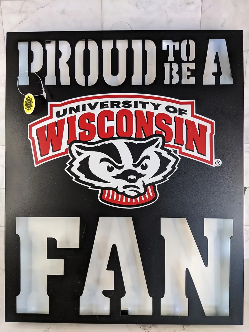 A black sign that is lighted with the words "Proud to Be a University of Wisconsin Fan" with an image of a badger and red lettering.