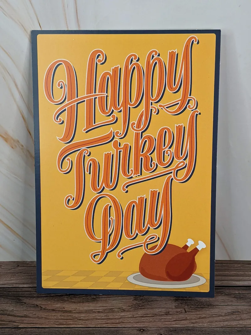 A Thanksgiving card with an image of a cooked turkey and the words "Happy Turkey Day."