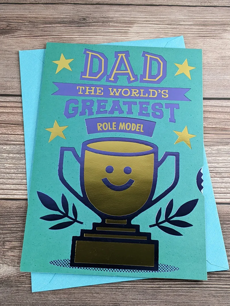 An interactive Hallmark Father's Day with a teal background and an image of a gold trophy.