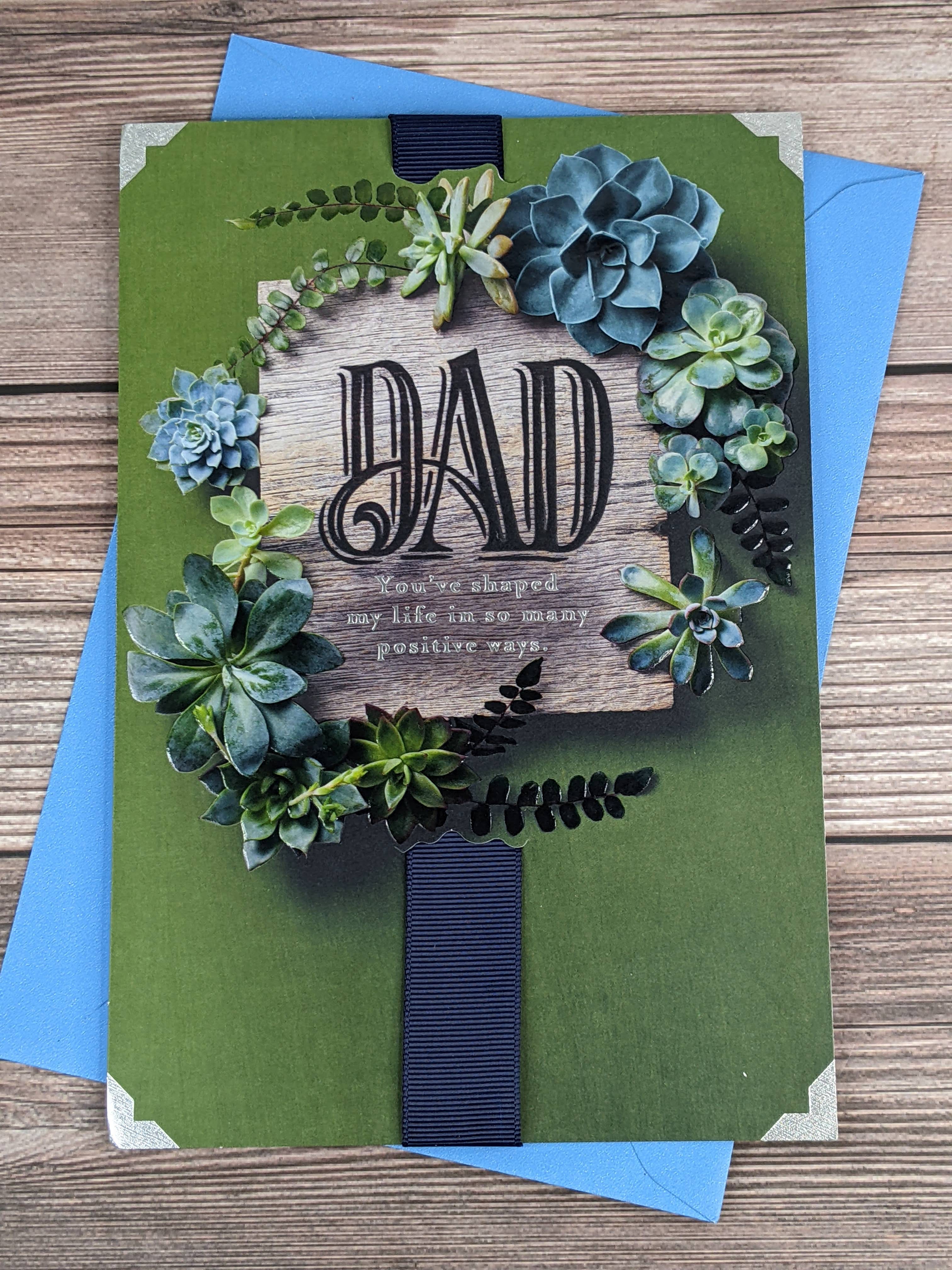 A Hallmark Father's Day greeting card with a green background and an image of an arrangement of succulent plants.