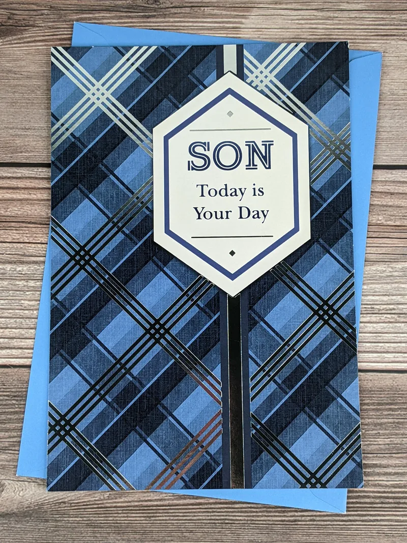 A Father's Day greeting card for a son, with a blue and silver plaid pattern on the cover.