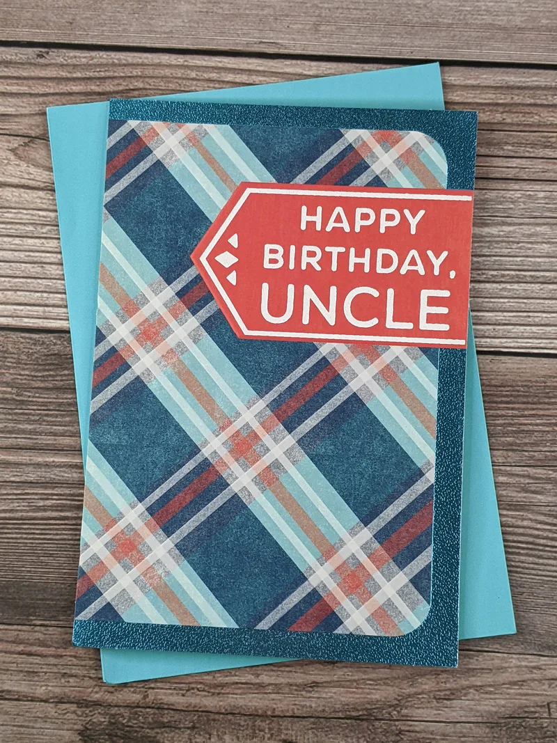 A birthday greeting card for an uncle with a blue and red plaid design on the cover.