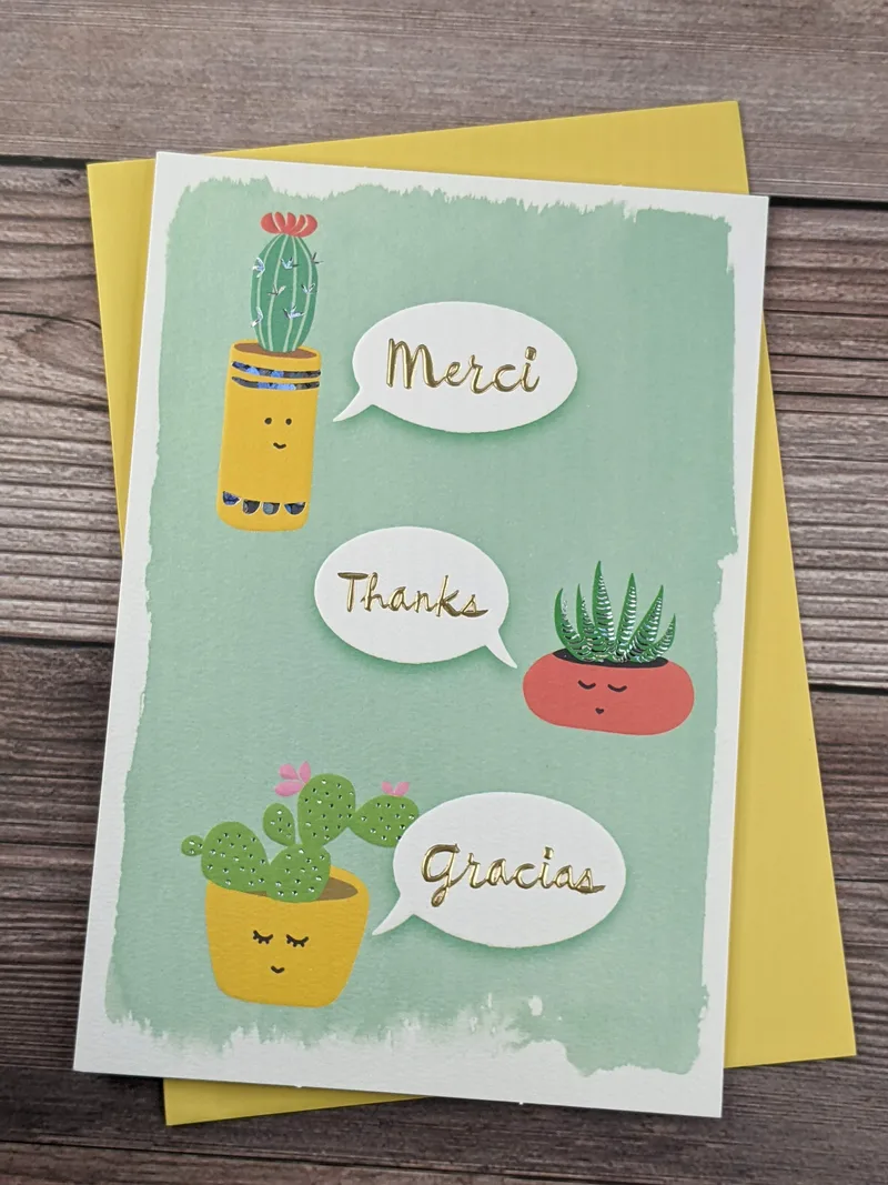 A Hallmark thank-you card with a green cover that has images of cacti and words of thanks.