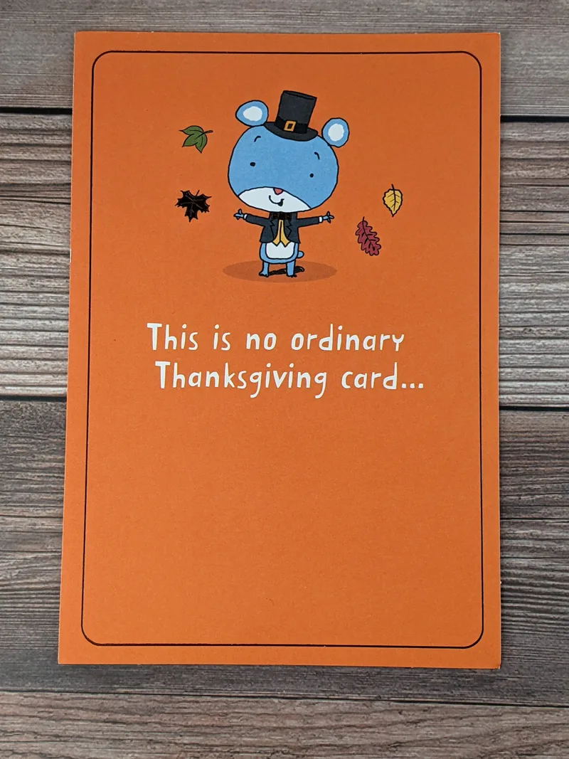 An orange Thanksgiving card with an image of a pilgrim mouse on the cover.