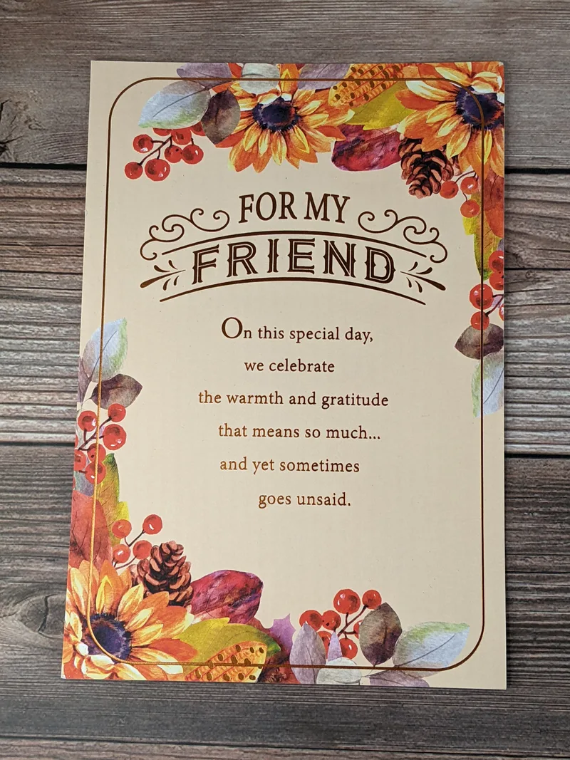 A friendship Thanksgiving card with images of sunflowers and red berries.