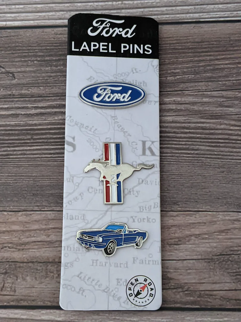 A set of 3 Ford brand lapel pins shaped like a Ford logo, a Mustang logo, and a Ford car.