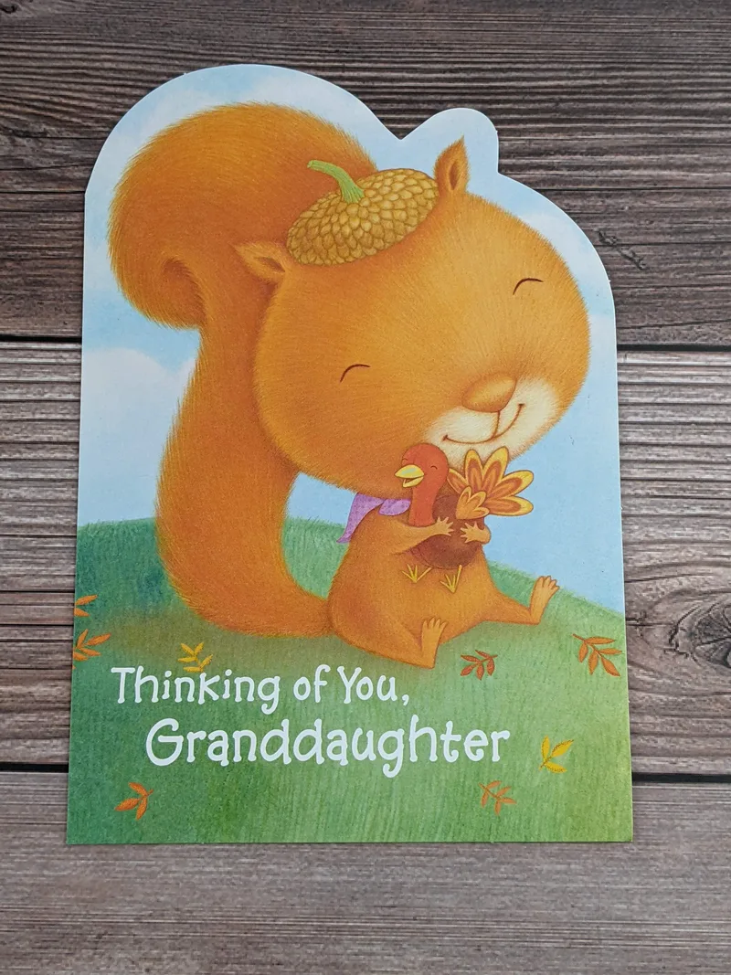 A thanksgiving card for a granddaughter with an image of a squirrel holding a turkey.
