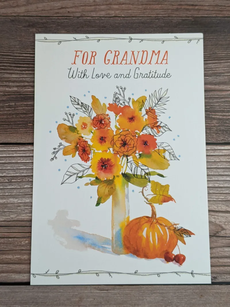 A thanksgiving card for a grandma with an image of flowers and a pumpkin.