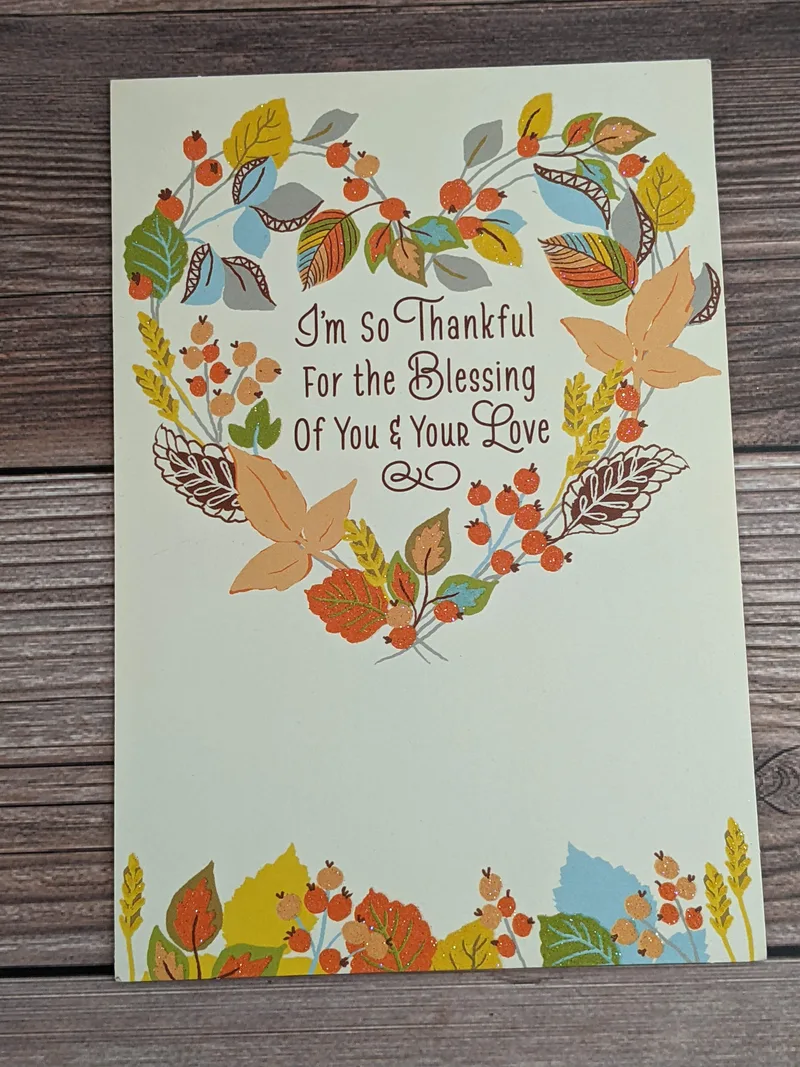 A thanksgiving greeting card for a spouse with an image of a heart shaped autumn wreath.