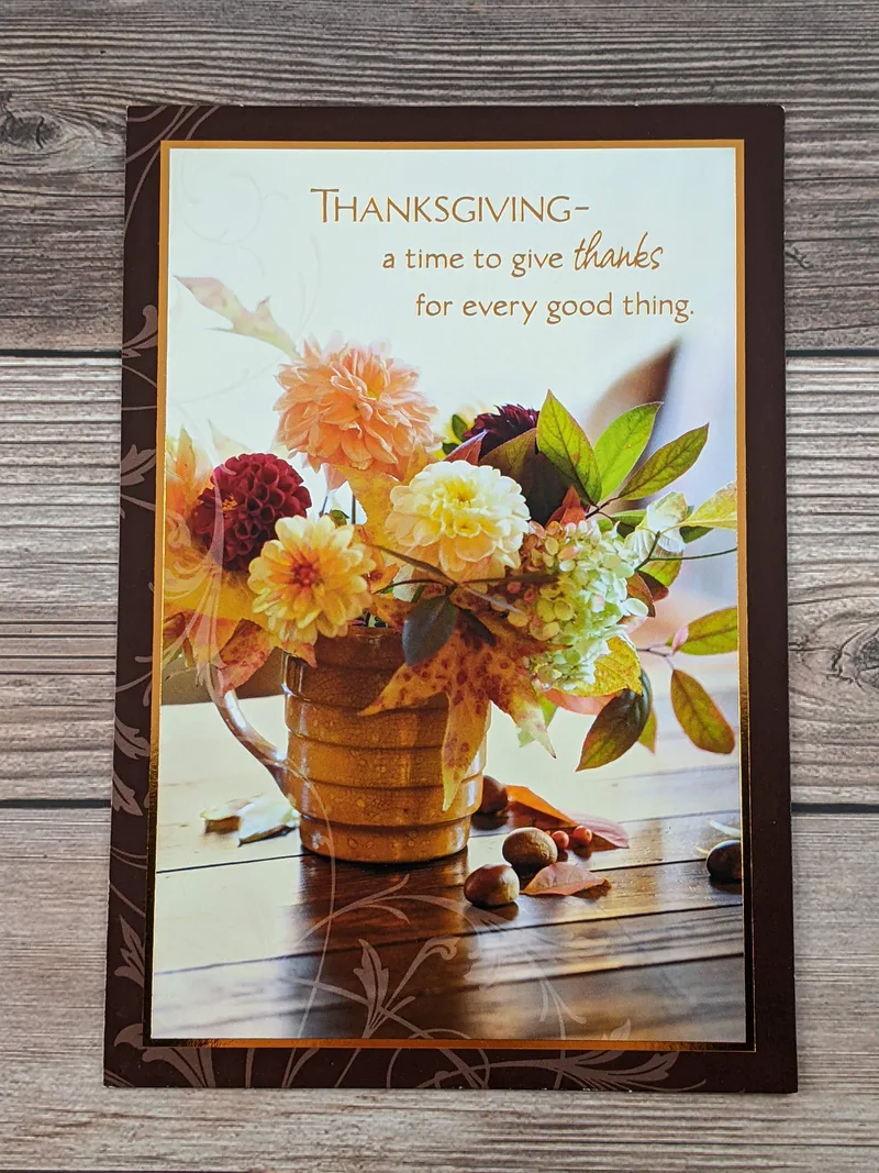 A Thanksgiving greeting card with an image of a vase of flowers.