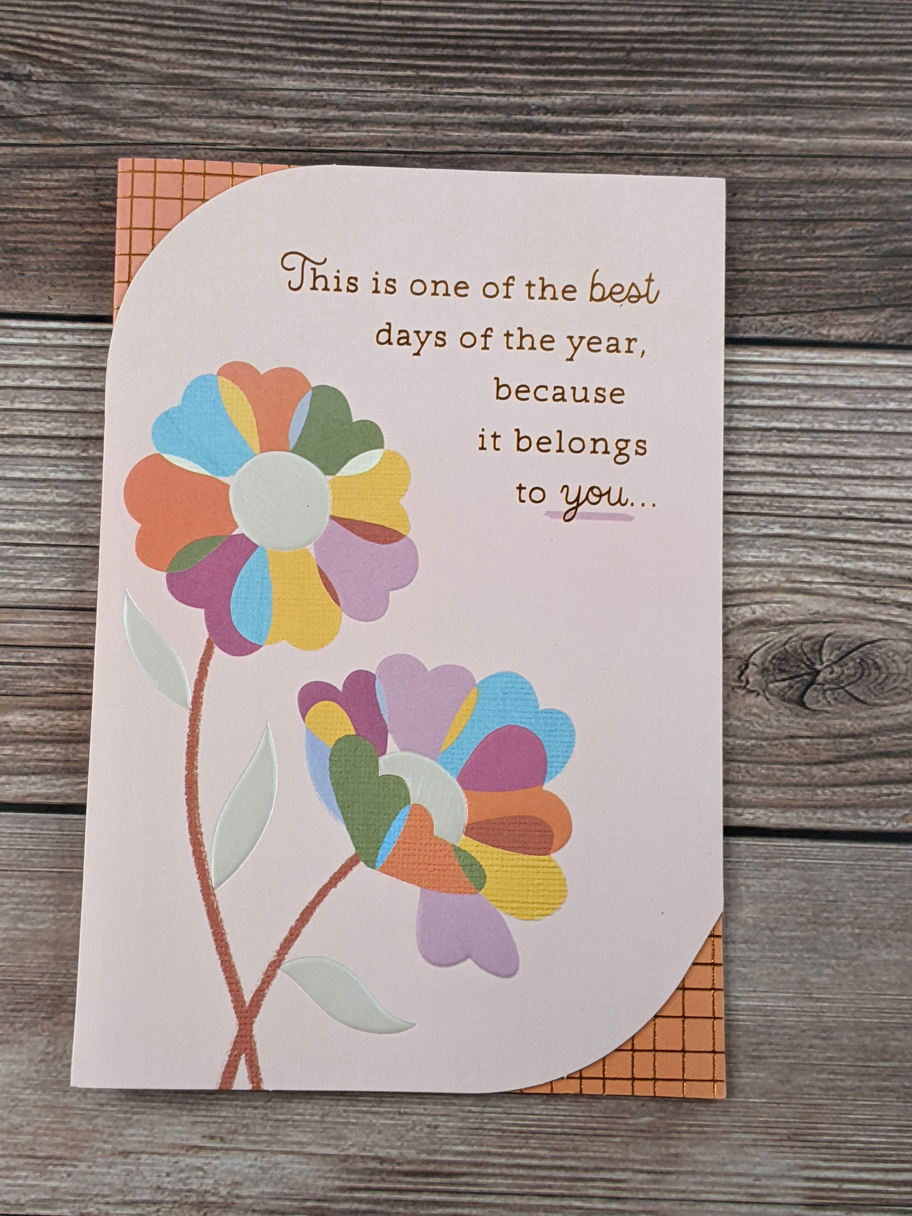 A greeting card with a design of colorful flowers on the cover.