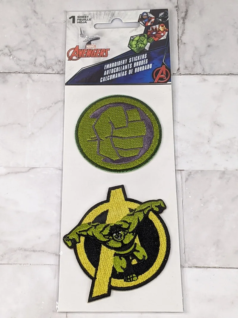 A pack of 2 embroidered green stickers by Marvel featuring the character Hulk.