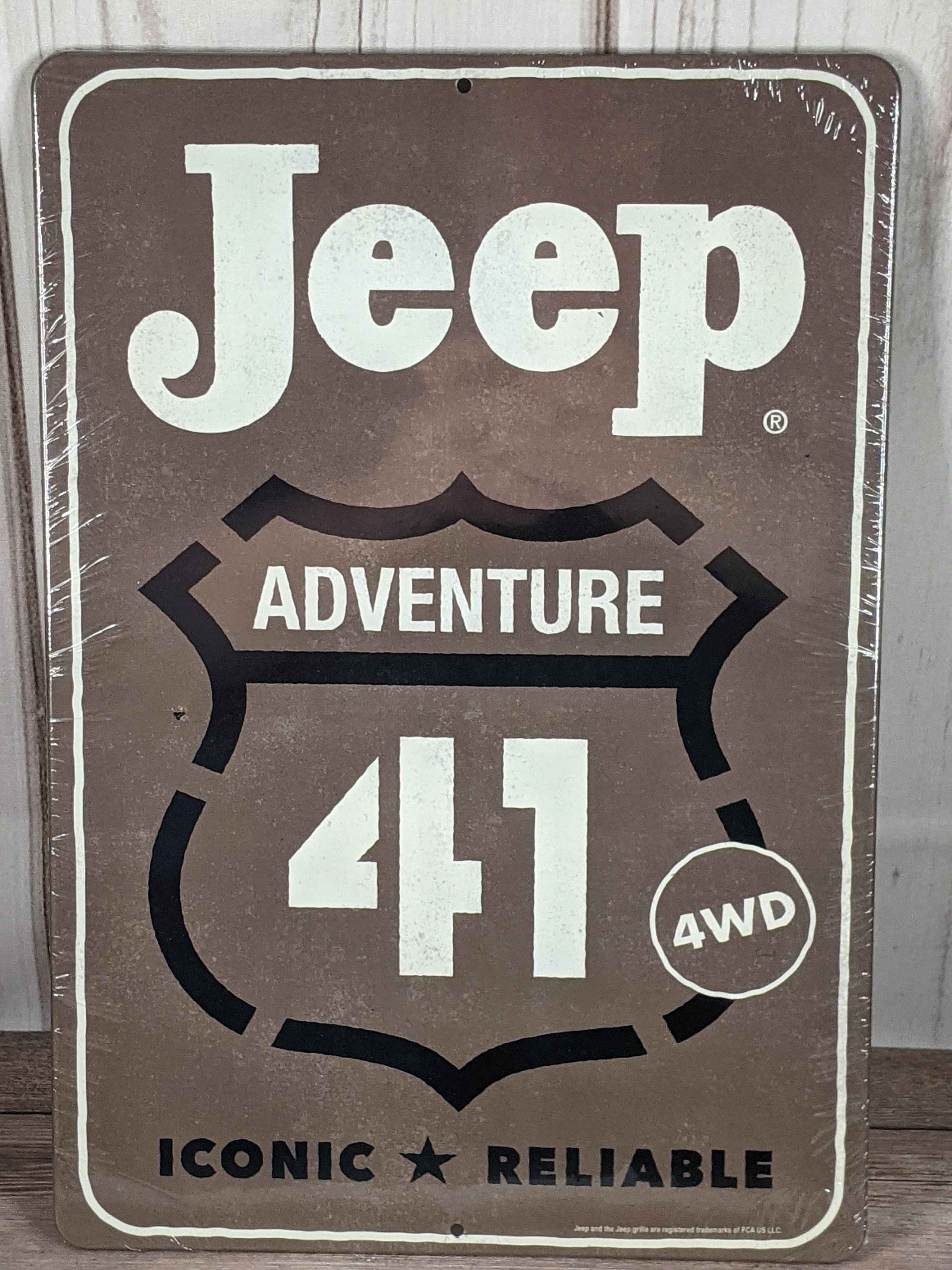 A gray metal wall sign with the words Jeep Adventure 41.