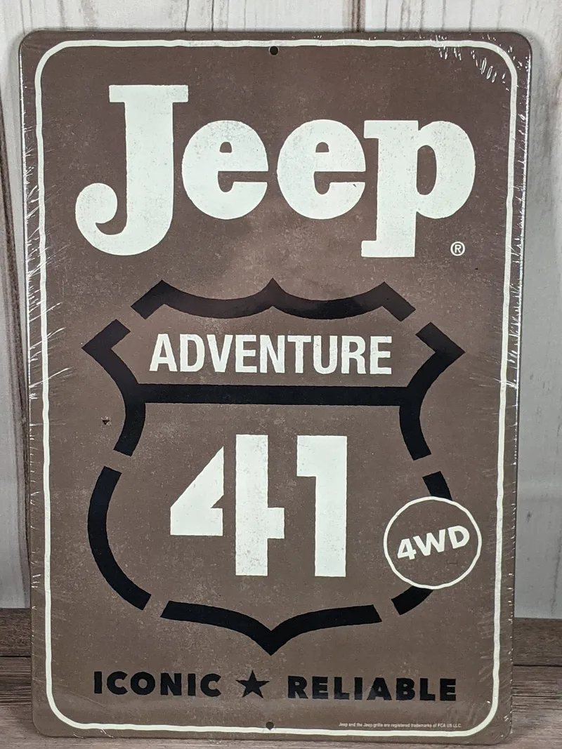 A gray metal wall sign with the words Jeep Adventure 41.