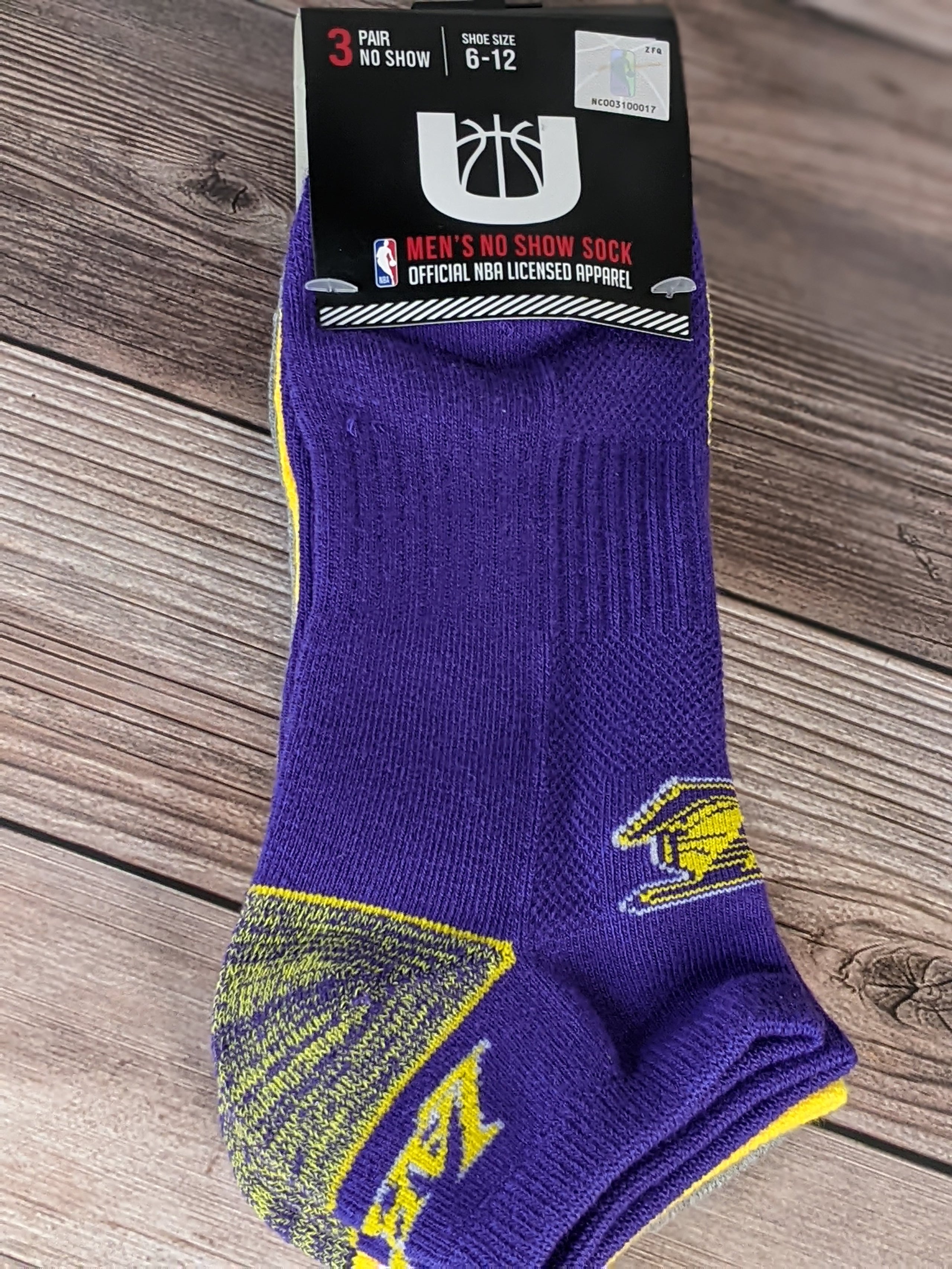Three pairs of new socks featuring the LA Laker's logo with purple, yellow, and gray designs.
