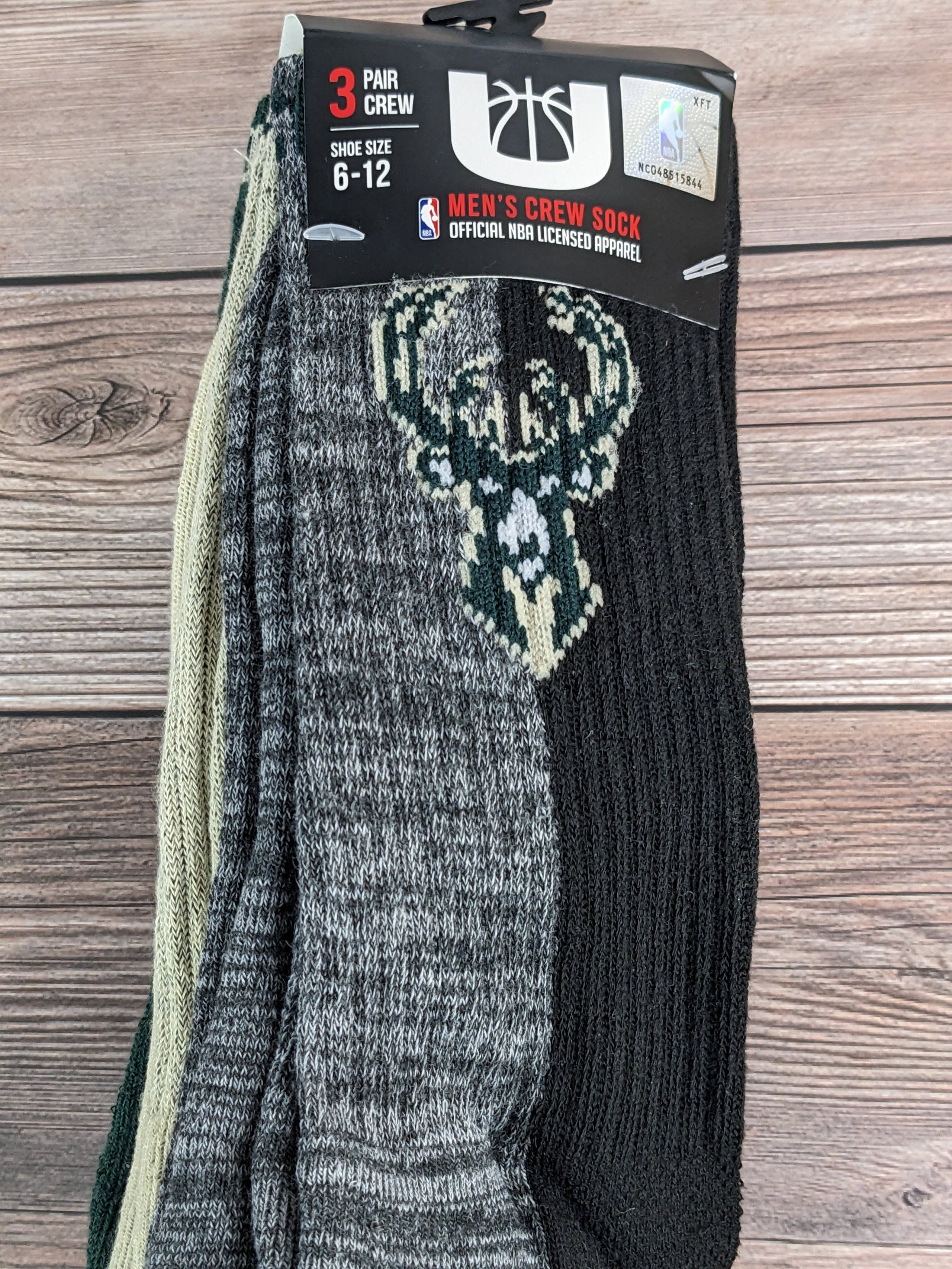 A pack of Gray/Black, Tan/Green, and Black/Green Color-Block Crew Socks for MEN, with the NBA Milwaukee Bucks logo.