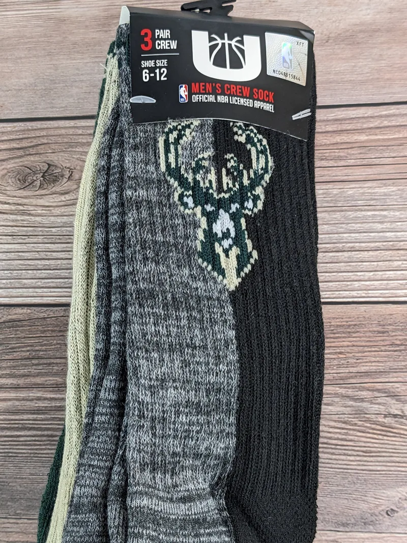 A pack of Gray/Black, Tan/Green, and Black/Green Color-Block Crew Socks for MEN, with the NBA Milwaukee Bucks logo.