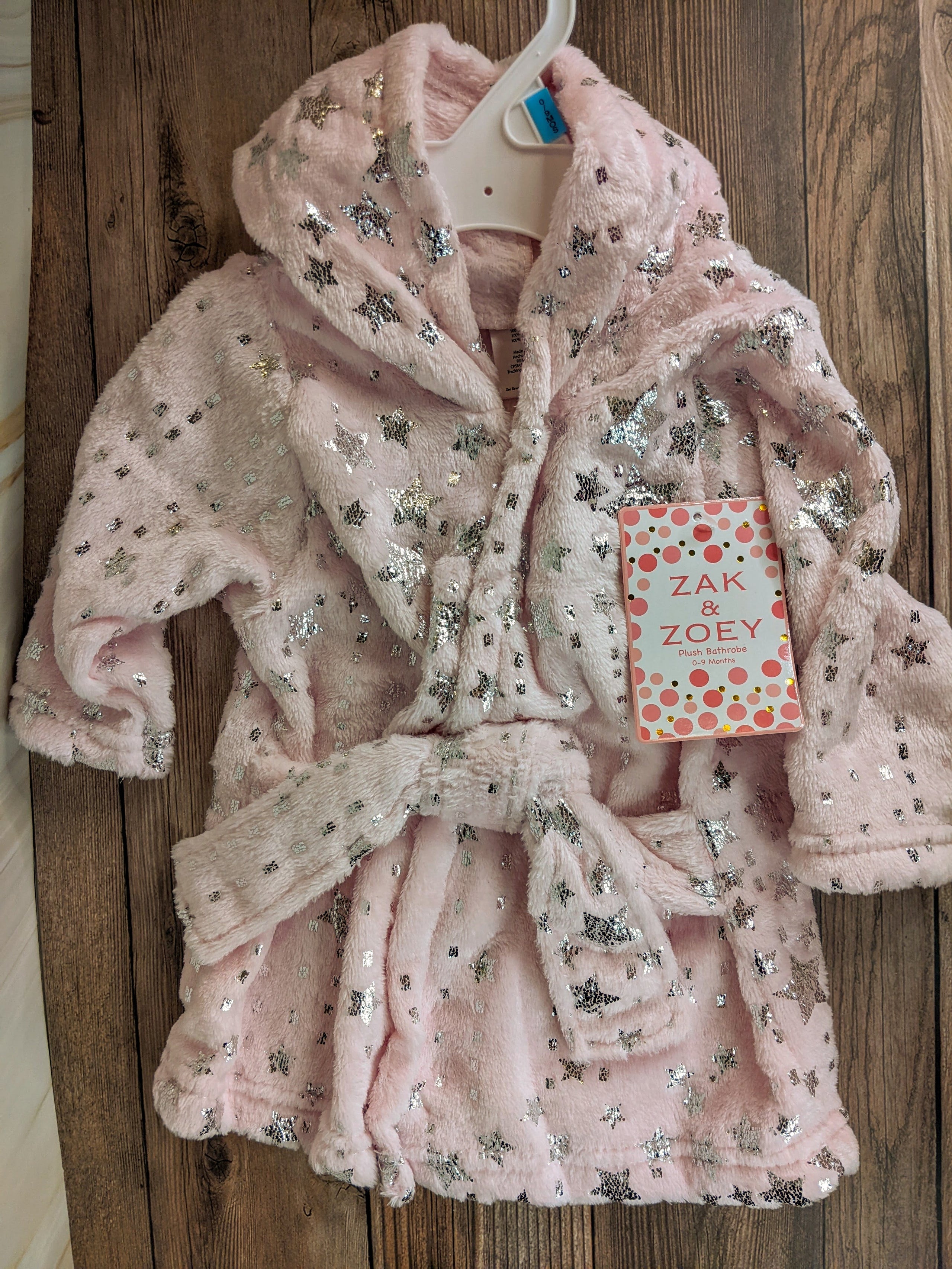 This cute baby bathrobe is soft pink with a design pattern of silver stars! 