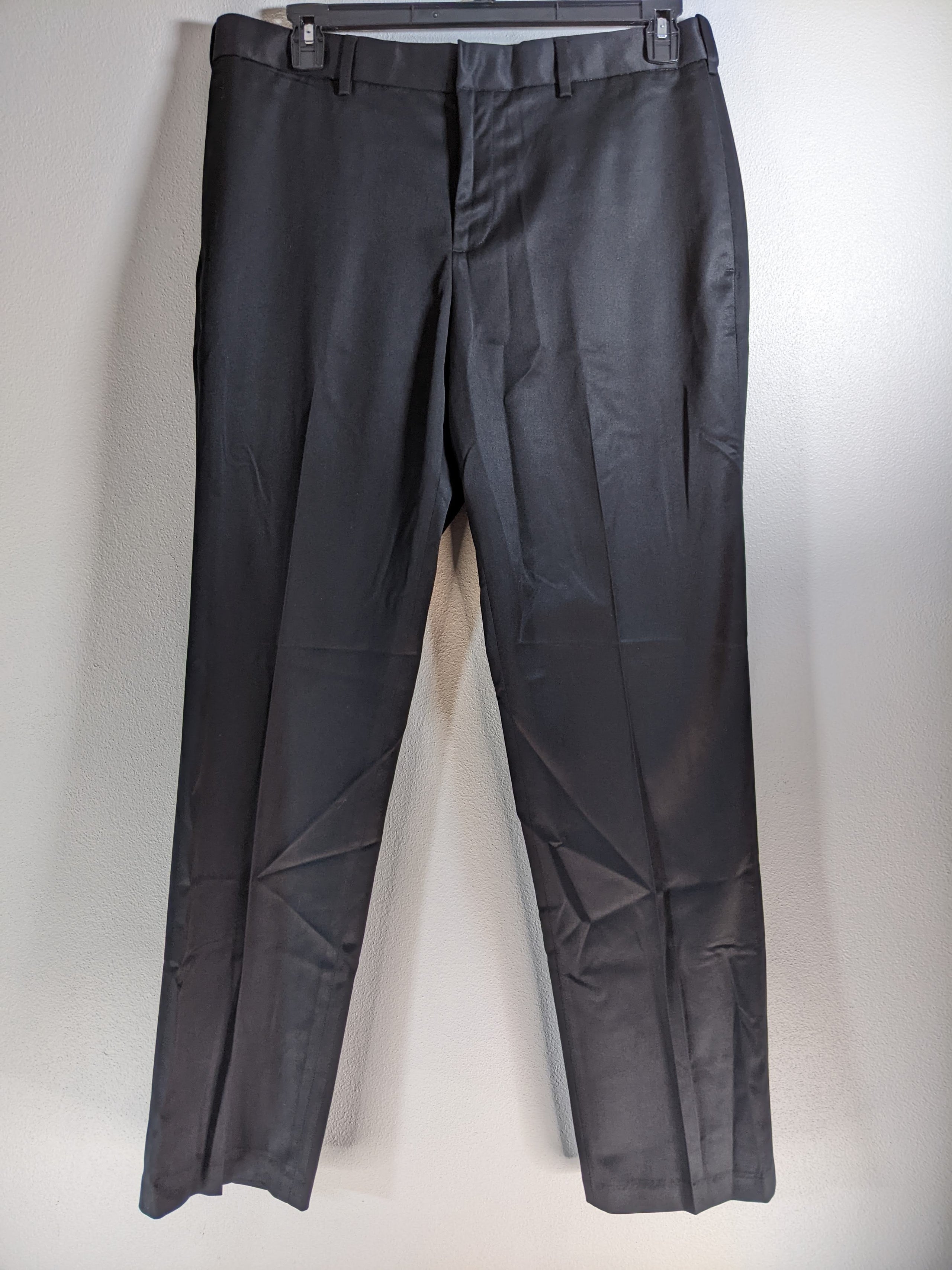 A pair of discounted black pants for men by Perry Ellis.