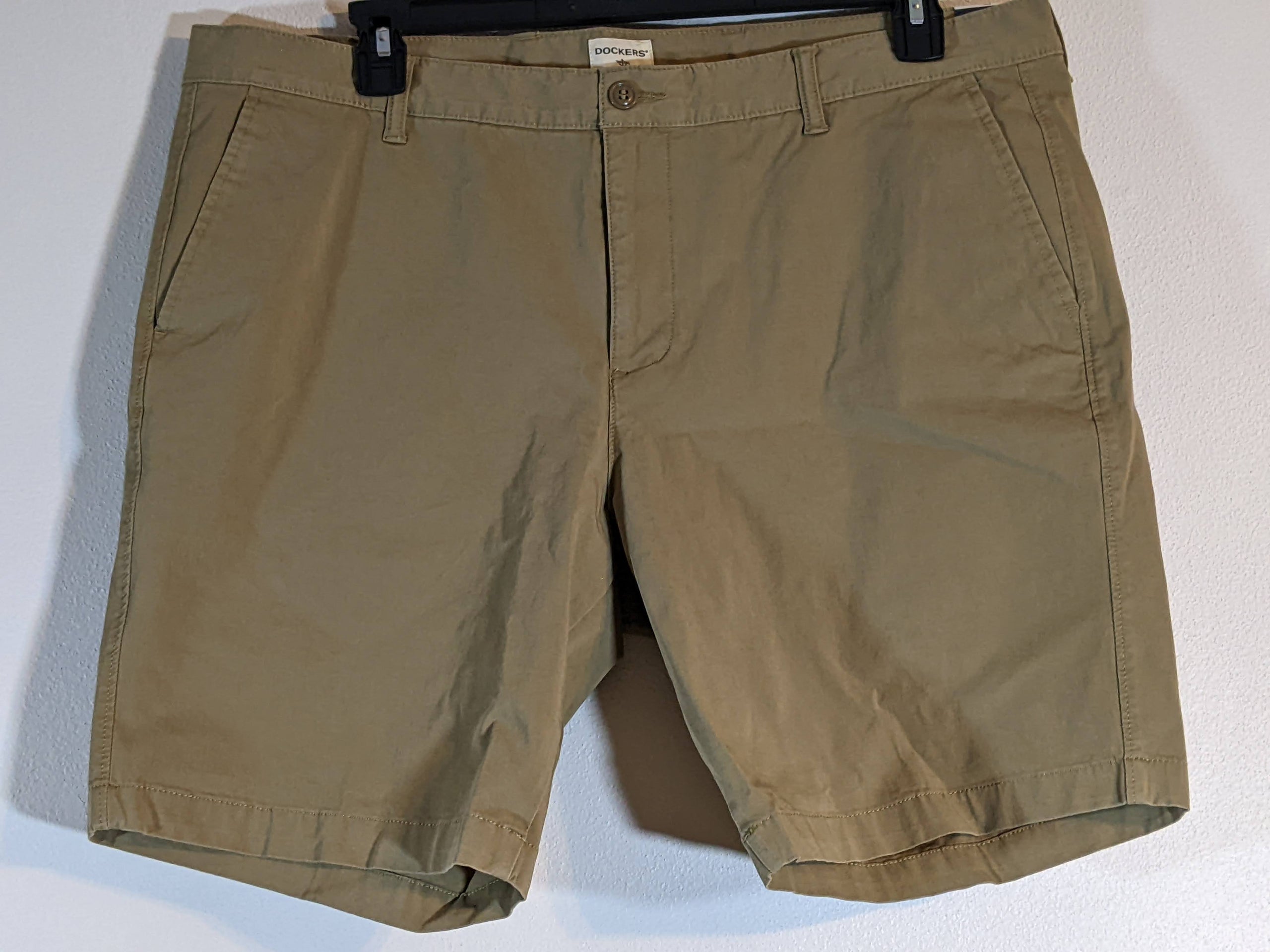 A tan pair of men's size 40 khaki shorts by Dockers.