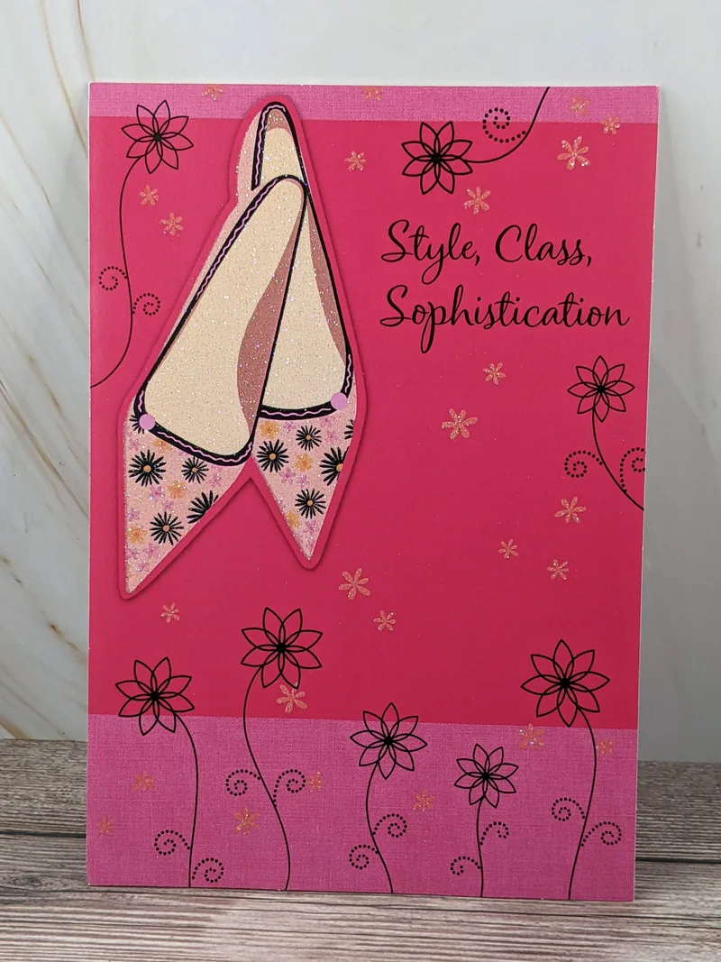 A bright pink birthday card for a daughter with an image of a pair of pink high heeled shoes.