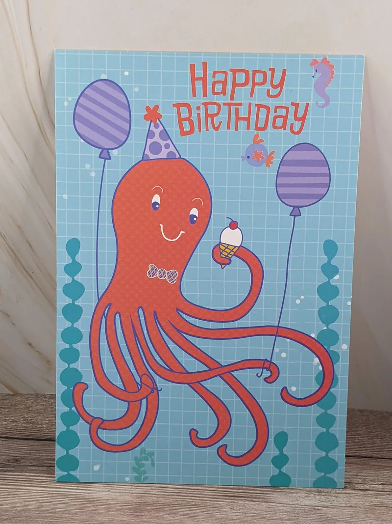 A happy birthday card for a boy, with a blue cover and an image of a red octopus.