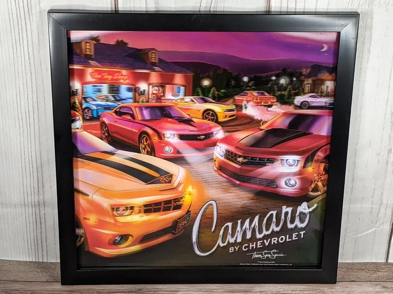 A wall sign with a lenticular 3-D effect of several Camaro cars in various colors.