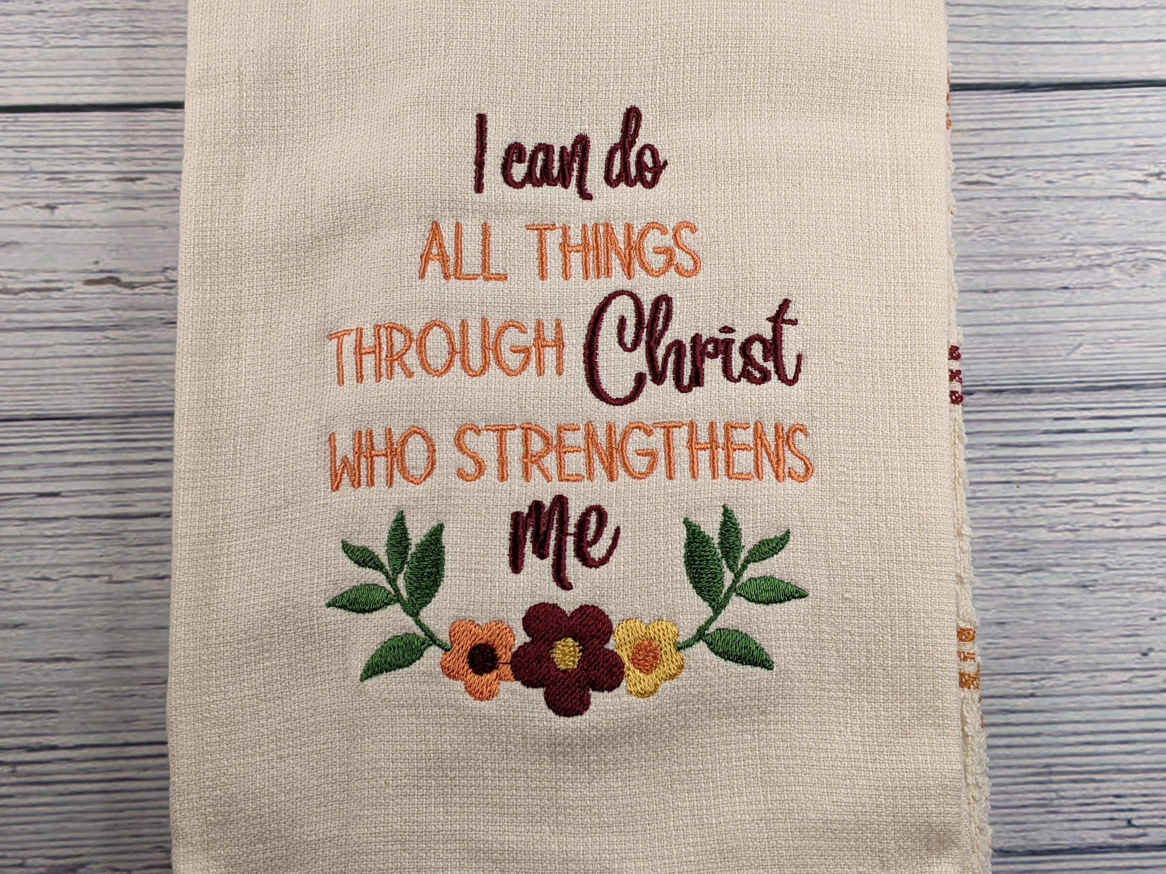 A hand towel with a Bible verse embroidered (Philippians 4:13).