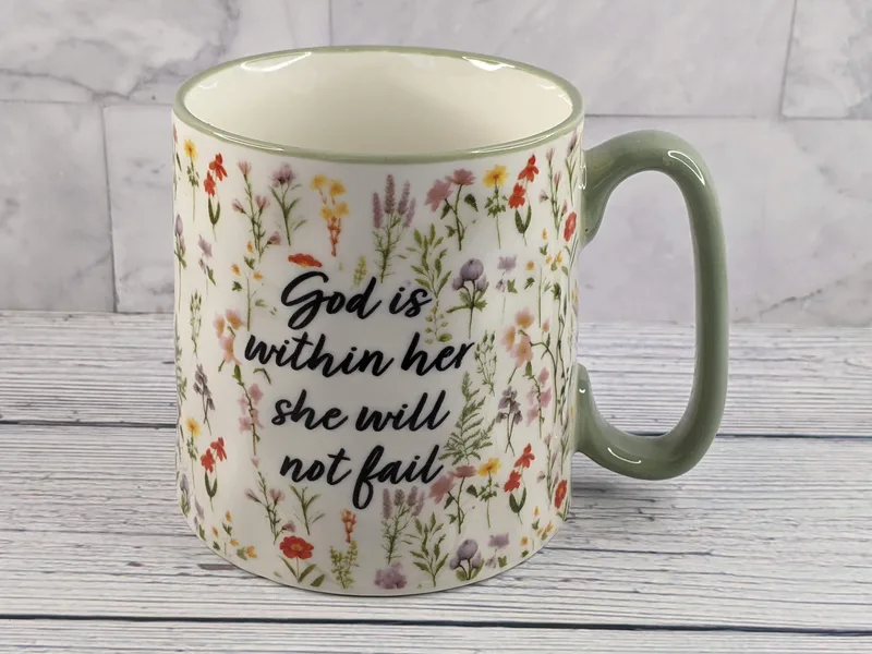 A Christian mug with a flower design and a Bible verse (Psalm 46:5).