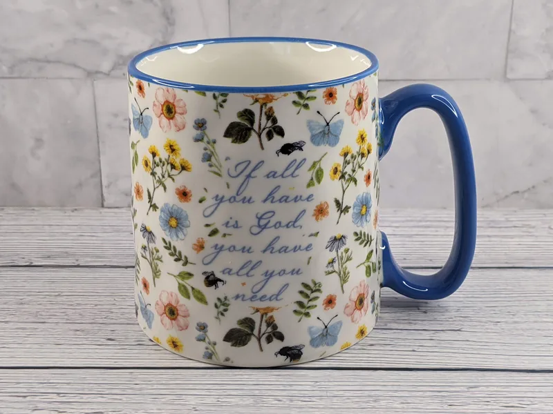 A Christian mug for a woman with a flower design and a religious message.