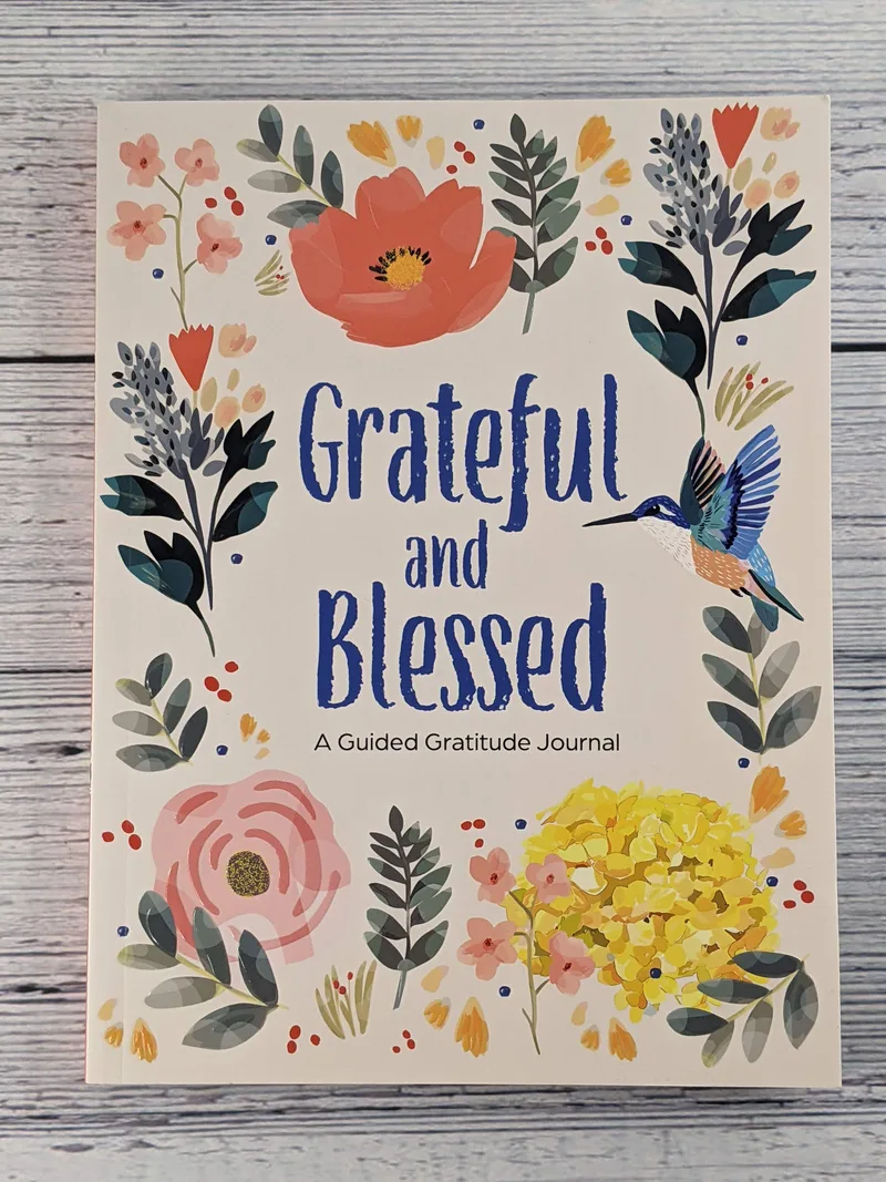 The front of a gratitude journal with a flower design.