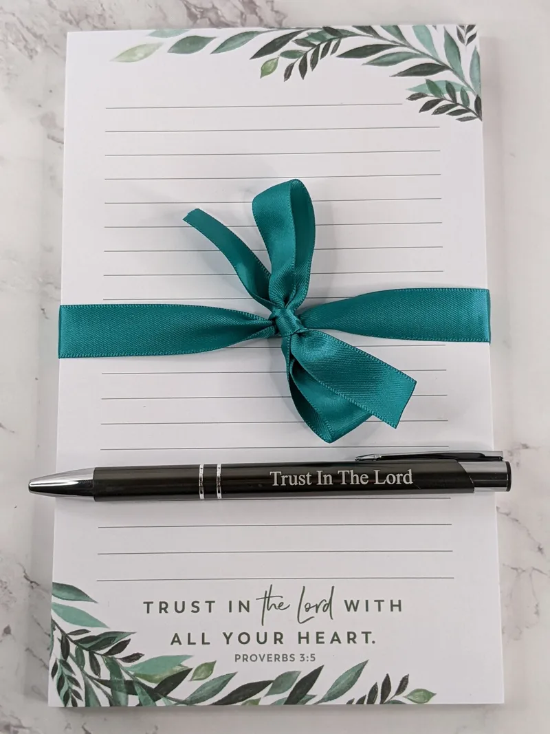 A Christian Notepad and Pen with a Bible Verse "Trust in the Lord"
