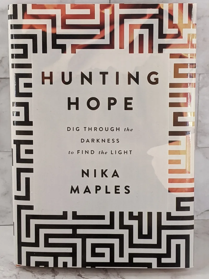 A hardcover book by Nika Maples with the title Hunting Hope.