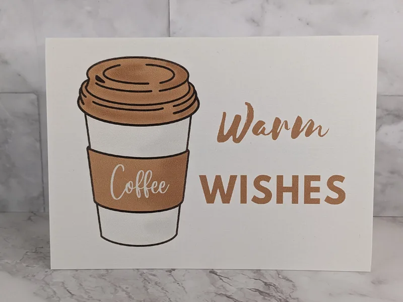 A coffee themed greeting card wishing someone warm wishes for a blessed day.