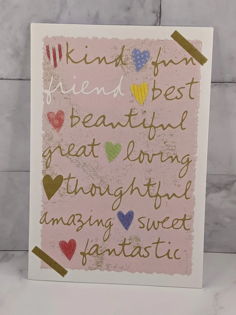 A pink greeting card of friendship with a design of hearts and a message about a friend being a sister you choose.