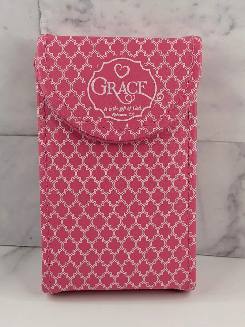 A grace themed manicure set in a pink suede case with a white pattern design.