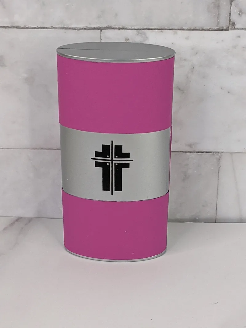 A manicure set in a pink case that features the image of a cross.